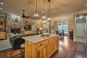a kitchen and living room with a couch and a table at Spacious Golf Course Getaway in Hot Springs! in Hot Springs Village