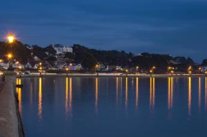 a view of a large body of water at night at The Canford in Poole