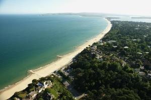 an aerial view of a beach and the ocean at The Canford in Poole