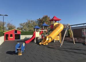 a playground with a slide and a play structure at Woodthorpe Leisure Park in Strubby
