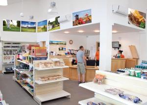 a man standing at a counter in a store at Woodthorpe Leisure Park in Strubby