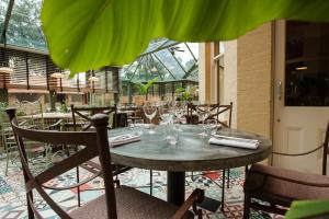 a table in a restaurant with a green umbrella at The Canford in Poole