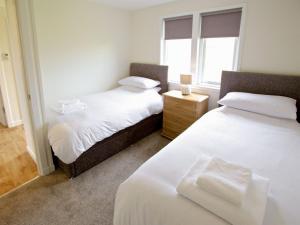a bedroom with two beds and a window at Rockworks Chalets No,5 - Uk7044 in Saint Marys