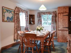 a dining room with a wooden table and chairs at Tudor House in Easingwold