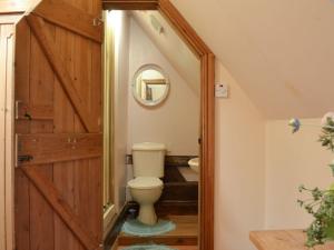 a bathroom with a toilet and a wooden door at Tudor House in Easingwold