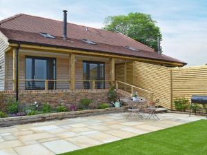 a house with a garden and a patio at Poachers View-ukc2488 in Mountfield
