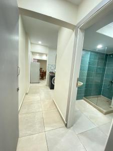 a bathroom with a walk in shower and a glass door at Zafero beach FAMILIES ONLY in Alexandria