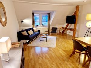 a living room with a couch and a table at Hofgarten Apartments in Aschaffenburg