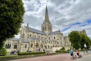 a large cathedral with people riding bikes in front of it at Wickland Cottage in Chichester
