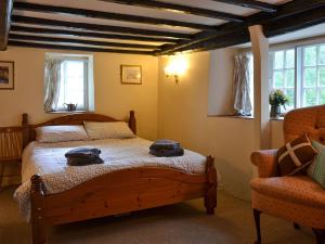 a bedroom with a bed with two bags on it at Brambley Meadow- Uk11725 in Kentisbury