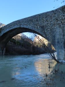 an old stone bridge over a river at Auberge De Calendal in Aiglun