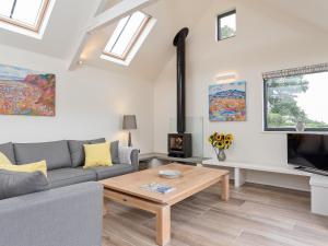 a living room with a couch and a coffee table at The Old Piggery in Sidbury