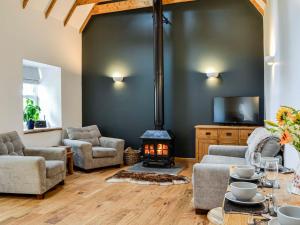 a living room with a couch and a fireplace at Cullew Bothy in Pearsie