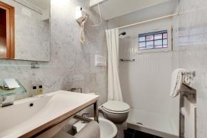 a white bathroom with a toilet and a sink at Leo APARTMENT LOC-03081 in Venice
