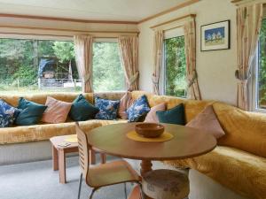 a living room with a couch and a table at Spinney Retreat in East Wellow