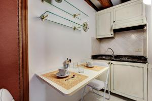 a small kitchen with white cabinets and a counter at Leo APARTMENT LOC-03081 in Venice