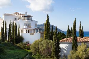 a house on a hill with cypress trees at Anassa in Polis Chrysochous