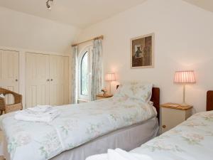 a bedroom with two beds and a window at Jubileum Lodge uk27999 in Watton