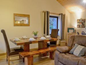 a living room with a wooden table and a couch at Glen View in Buchanty