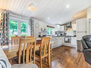 a kitchen and dining room with a table and chairs at Laurel Lodge in Willington