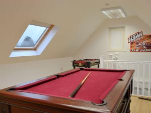 a pool table in the middle of a room at Hawthorn Cottage in Stranraer