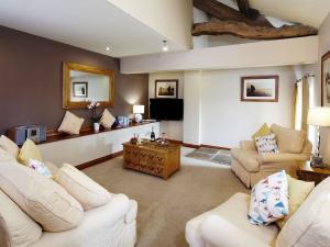 a living room with two couches and a tv at Birch Cottage - Uk4185 in Hazlehead Bridge