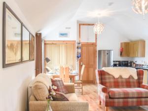 a living room with two chairs and a table at Mission House in Marvig