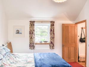 a bedroom with a bed and a window at Mission House in Marvig