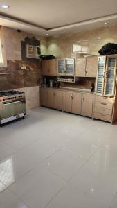 a large kitchen with stainless steel appliances in a room at مزرعة الطيبين in Buraydah