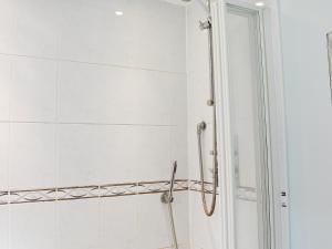 a bathroom with a shower with a glass door at Yew Tree Cottage in Arford