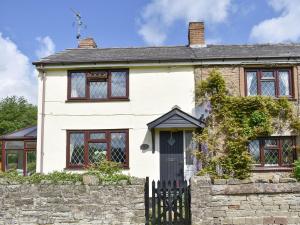 a white house with a black door at Oak Tree Cottage - E5062 in Lydbrook