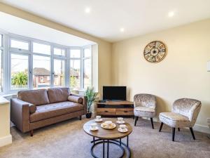 a living room with a couch and a tv at The Laurels in Clenchwarton