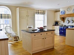 a kitchen with an island in the middle of a room at Awelfa - On7 in Aberaeron