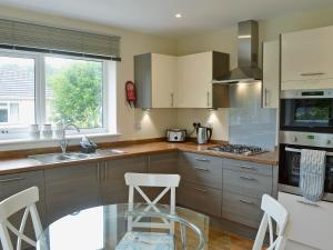 a kitchen with a sink and a stove top oven at Tegen in Tywardreath