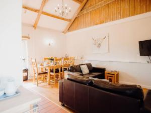 a living room with a couch and a table at Goose Cottage- Uk6737 in Lydstep
