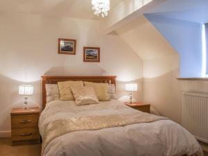 a bedroom with a large bed with two night stands at The Nook in Kirkby Lonsdale