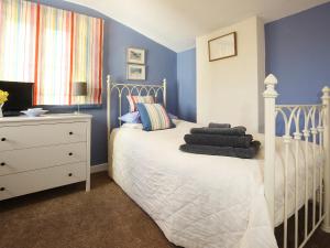 a bedroom with a white bed and a dresser at Foxes Reach in Trelleck