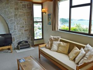 a living room with a couch and some windows at Berlewen - Ukc3536 in Mevagissey
