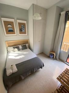 a bedroom with a bed with two towels on it at Center Madrid habitaciones in Madrid