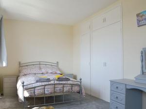 a bedroom with a bed and a dresser and a drawer at Valley View in Morwenstow