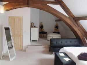 a bedroom with a bed and a couch in a room at St Albans Church - 28165 in Treherbert