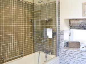 a shower with a glass door in a bathroom at The Carriage House in Watermillock