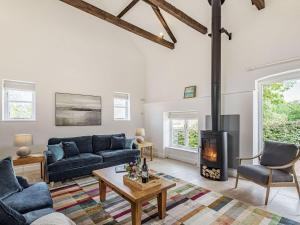 a living room with a couch and a fireplace at The Granary in Braunston