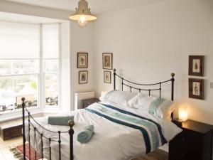 a bedroom with a bed and a window at Bay House in Hastings