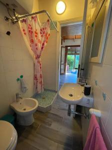 a bathroom with a shower and a sink and a toilet at -EXCLUSIVE PRIVATE VILLA- Villasimius in Villasimius