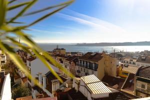 a view of a city with buildings and the ocean at Olympo Shared flat with Amazing River view in Lisbon