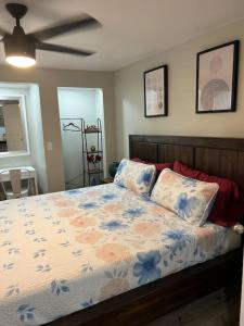 a bedroom with a large bed with a ceiling fan at Peaceful getaway and Explore Tampa in Oldsmar
