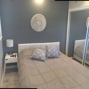 a bedroom with a bed with two pillows on it at Walk Everywhere Heart of Downtown St Pete in St Petersburg