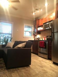 a living room with a couch and a kitchen at Walk Everywhere Heart of Downtown St Pete in St Petersburg