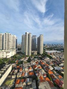 an aerial view of a city with tall buildings at Madison Park Apartment Near Mall Central Park in Jakarta